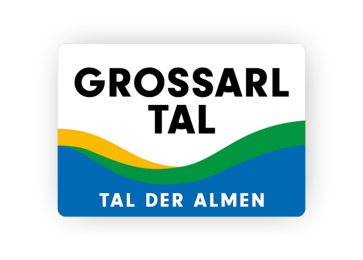 Logo s GROSSARL TAL nad zvlněnými liniemi - žlutá, zelená, modrá - TAL DER ALMEN dole; ideální pro výlety s cyklistikou.