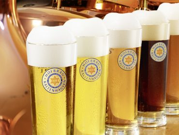 @Brau-Union-O¦êsterreich Sechs Gläser Hofbräu und Kaltenhausener Bier hintereinander, jedes in einer anderen Farbe und mit dicker Schaumkrone.