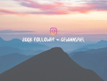 Silhouette eines Berggipfels bei Sonnenuntergang mit 200k Follower - Gewinnspiel und Instagram Logo in der Mitte.