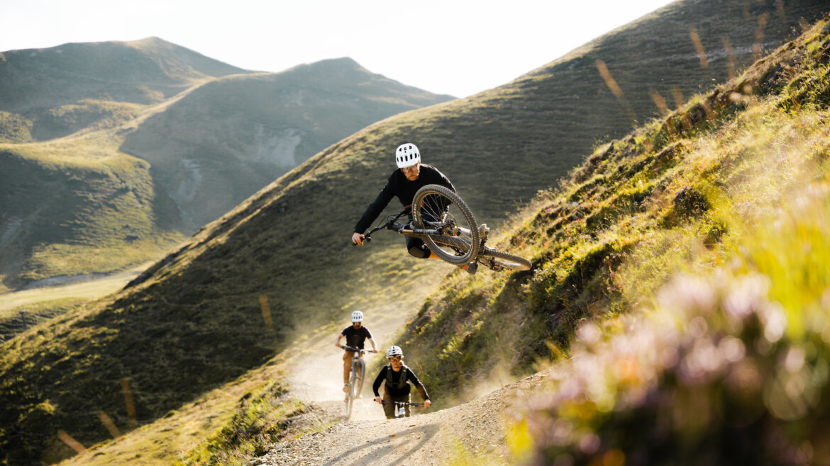 Biking _c-saalbach_com-moritz-ablinger 3 Bikers on a Trail, the first jumping high up in the air in Saalbach mountains (Enlarged view)