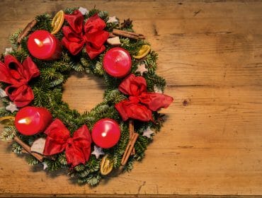 traditional red advent wreath with 4 candles