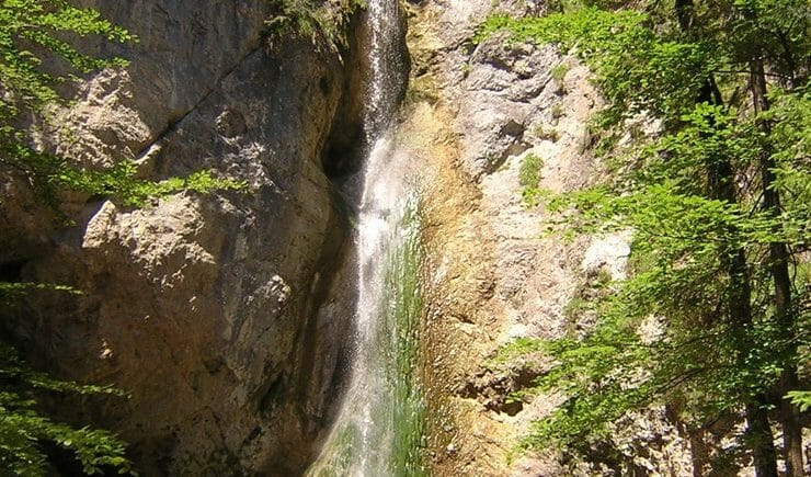 a large waterfall over a rocky cliff