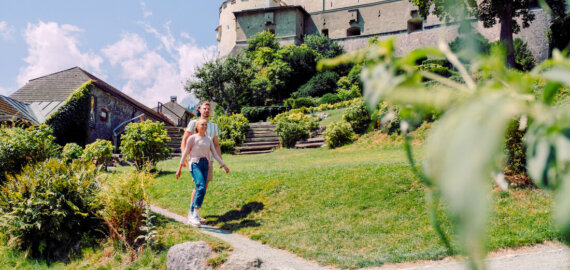 Young couple in front of Castle Hohenwerfen