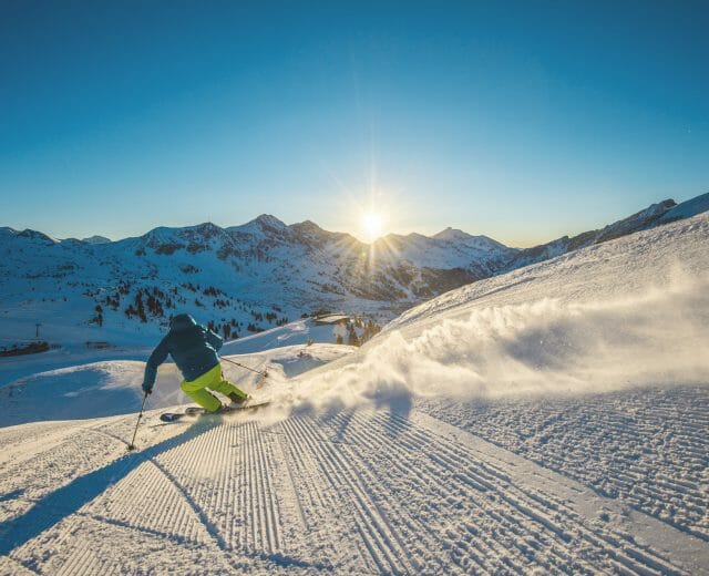 a man skiing on top of a snow covered mountain