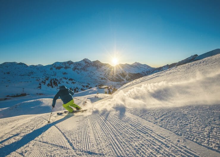 a man skiing on top of a snow covered mountain