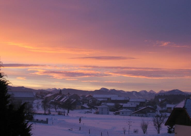 a picture in the evening of cottages covered with snow