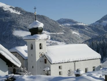 Tief verschneite Kirche von St. Koloman