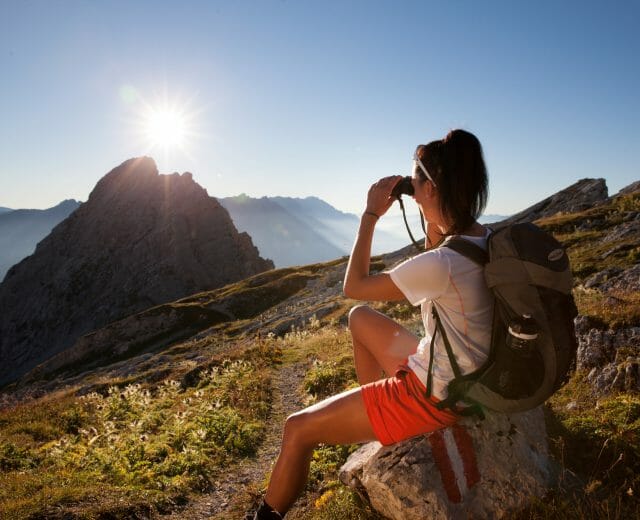 Salzburger Almenweg trail Hiker enjoying sunset at Salzburger Almenweg trail