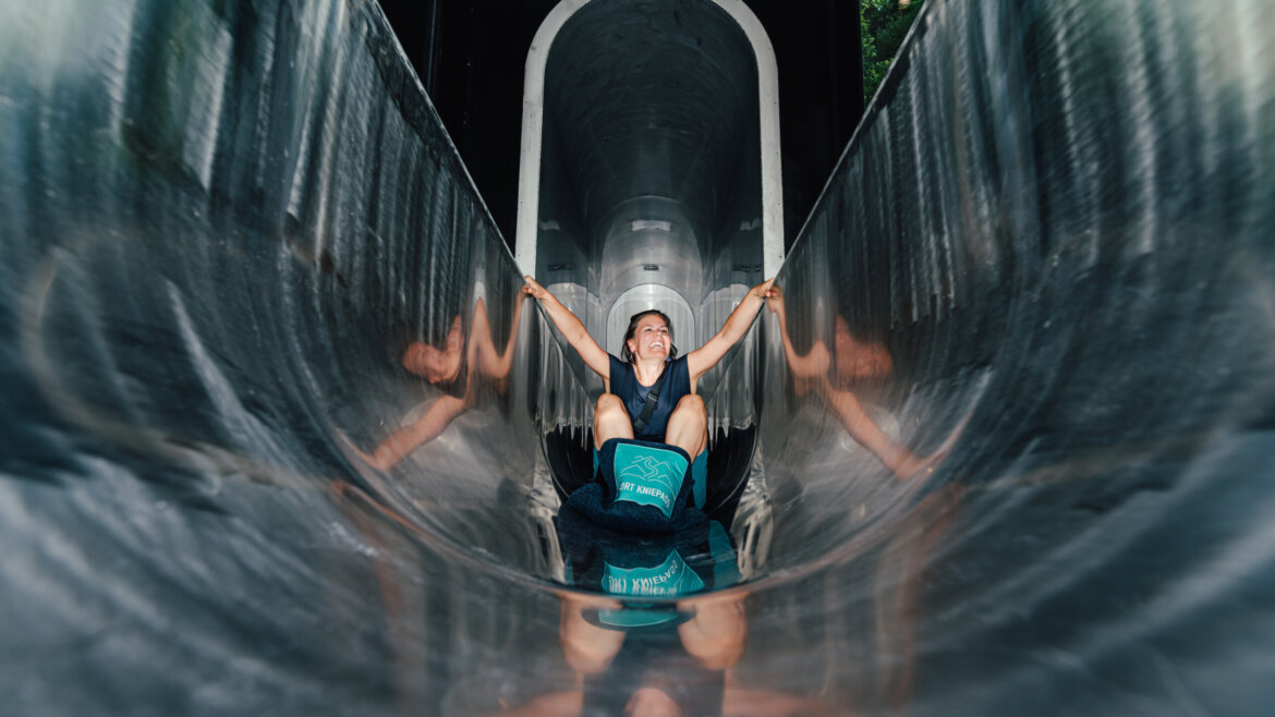 Tube slide inside with a child sliding down