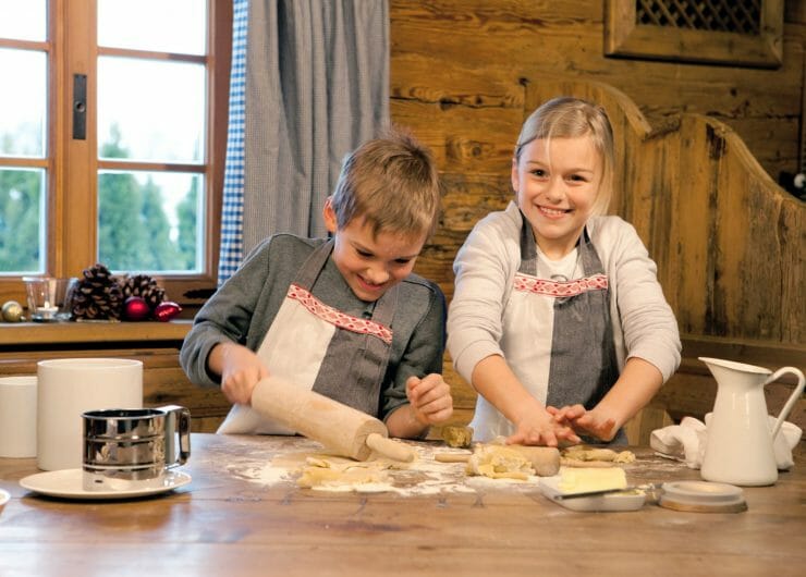 a little boy and a girl baking at a table