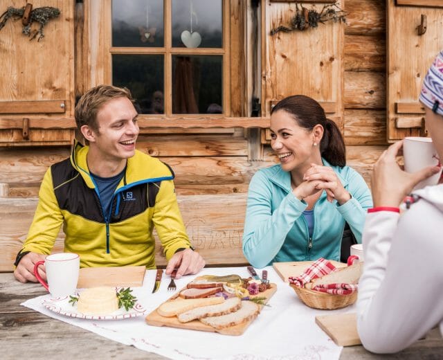 a group of people sitting at a table eating food