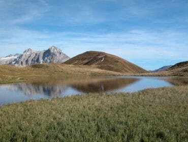 a body of water with a mountain in the background