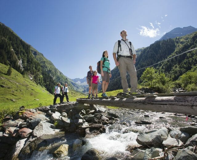 national park ranger guides a family through national park Hohe Tauern
