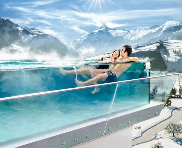 Relaxation in Skyline pool A couple relaxes in the skyline pool of the Tauern Spa Zell am See-Kaprun