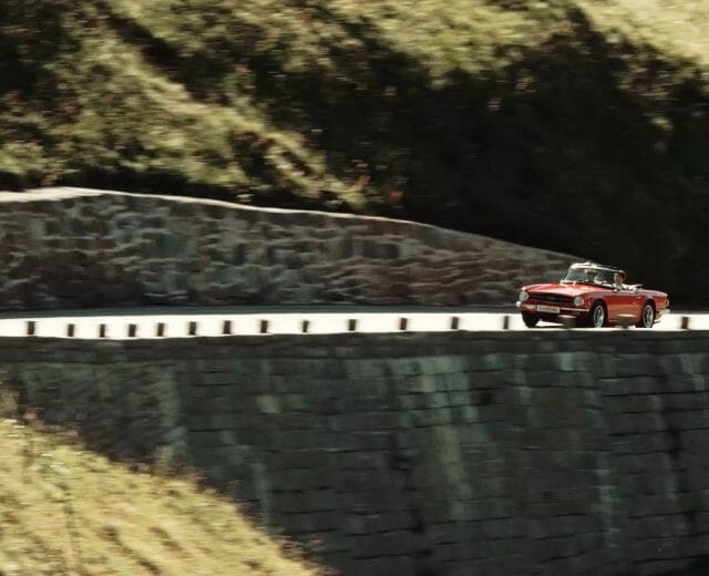 a car traveling on the side of the mountain