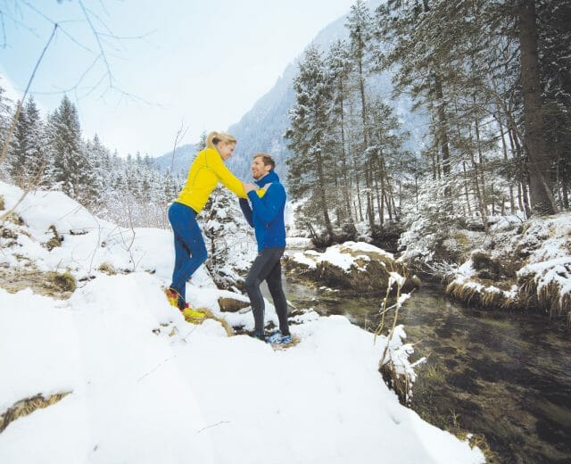 Winter jog Healthy couple jogging through winter landscape