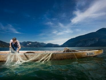 a man with a Fishing drop net in a fishing boat