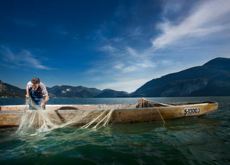 a man with a Fishing drop net in a fishing boat