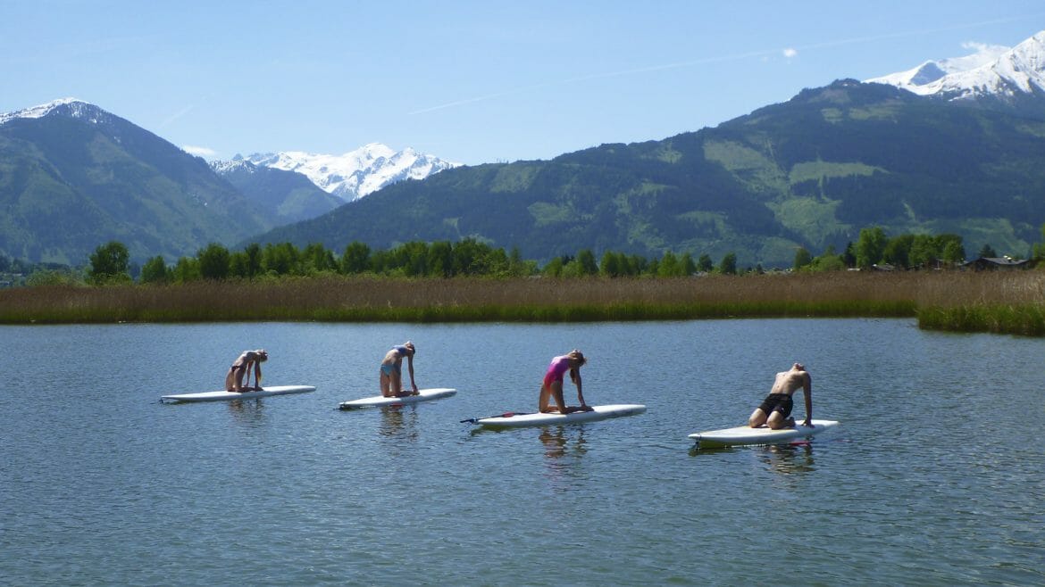 a group of people in a body of water with surf boards
