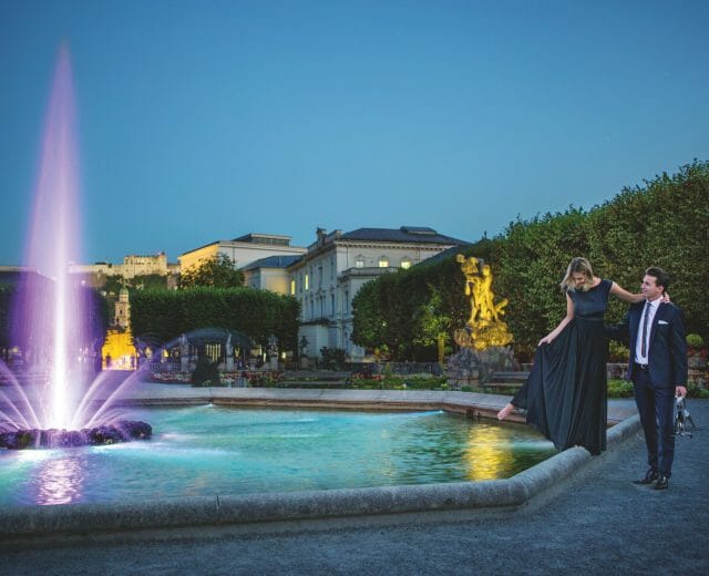 Pegasus fountain Festival couple dances at illumanted Pegasus fountain by night