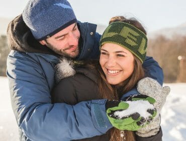 Healthy couple having fun in the snow