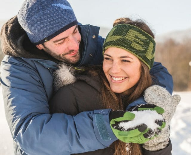 Healthy couple having fun in the snow