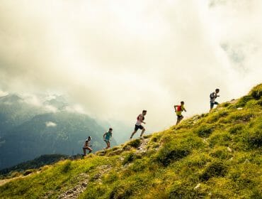 ait_bc_ss_18_michael_mueller__1088 a group of people walking on a grassy hill