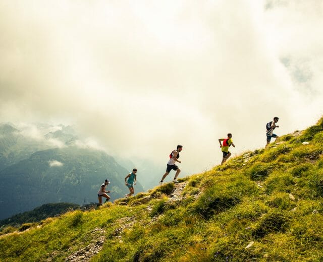 ait_bc_ss_18_michael_mueller__1088 a group of people walking on a grassy hill