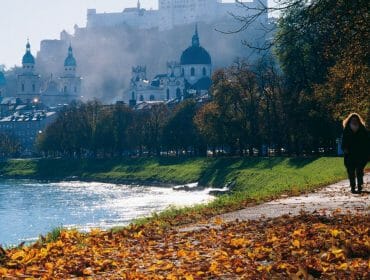 a woman walking next to a river