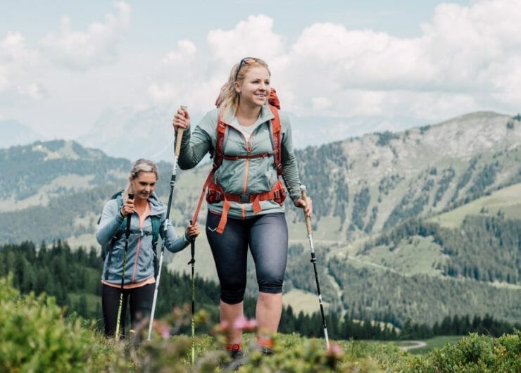 a woman standing in front of a mountain