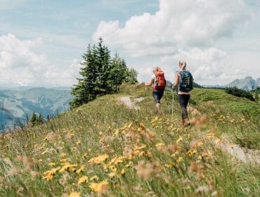 a man standing on a grassy hill