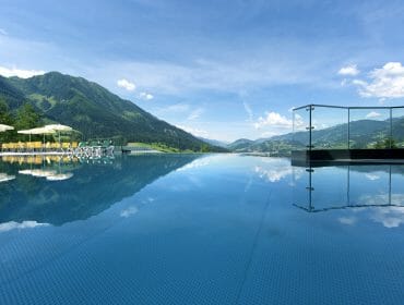 A pool with a view of mountains and blue sky.