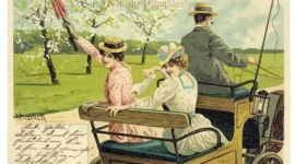 Two women and a man in vintage clothing ride in an old car at the Whitsun Festival; one waves a red umbrella.