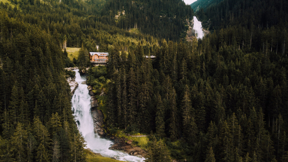 Waterfalls with huts surrounded by forest