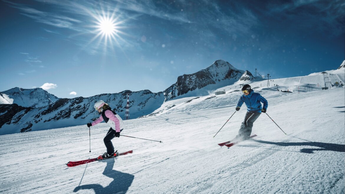 Two skiers on a perfectly groomed ski slope (Enlarged view)
