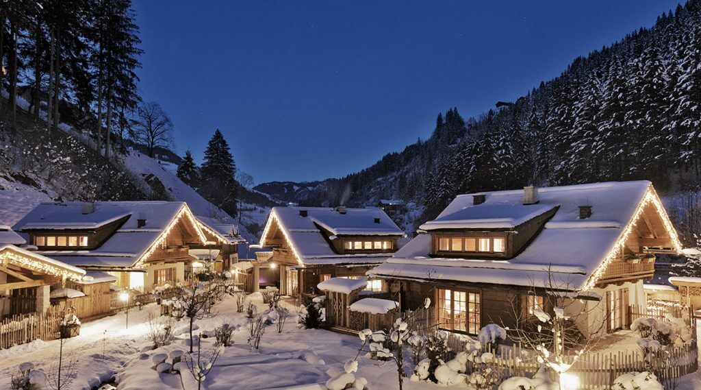 Holzlebn hut village in winter covered in deep snow