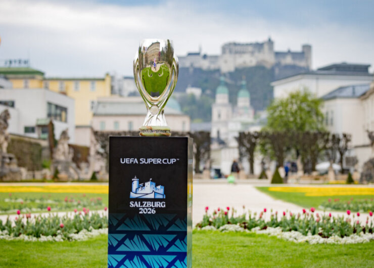 UEFA Super Cup 2026 Trophy UEFA Super Cup trophy on a Salzburg 2026 podium, with gardens and a castle in the background.