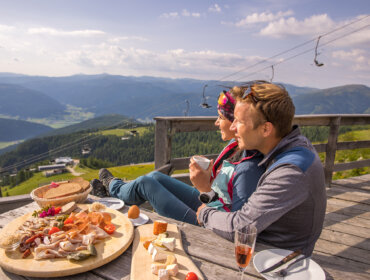 Két túrázó élvezi jól megérdemelt pihenőjét egy alpesi hüttében Két túrázó élvezi jól megérdemelt pihenőjét egy alpesi hüttében