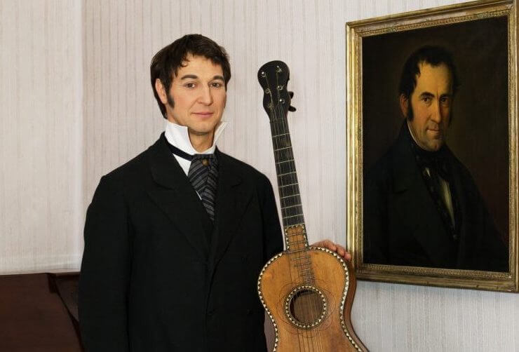 Franz Xaver Gruber képmása Joseph Mohr eredeti gitárjával a halleini Csendes éj-múzeumban
