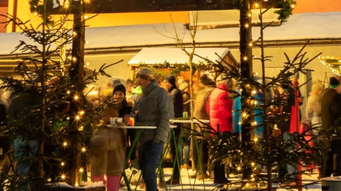 Ingresso al mercatino d’Avvento di Mariapfarr nel Lungau illuminato da luci calde e atmosfera festiva (Vista ingrandita)