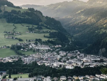 Małe miasteczko St. Johann na Ziemi Salzburskiej położone w zielonej dolinie pośród zalesionych gór i falistych wzgórz.